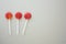 Three lollipops isolated on grey paper