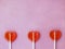 Three lollipops on pink background