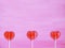 Three lollipops on pink background