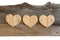Three Love Valentines wooden hearts on old Elm background