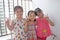 Three lovely baby girls are smilling with happy faces in their balcony