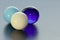 Three lovely coloured marbles on black surface - stock photo