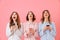 Three lovely young girls 20s wearing colorful striped pyjamas lo