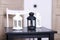 Three luminaire two white and one black on black wooden table. S