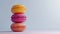 Three macaroons in a neat stack, their pastel hues evoking a sense of gourmet indulgence and simplistic aesthetic