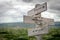 three magic words text engraved on old wooden signpost outdoors in nature