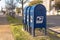 Three mailboxes on a city street