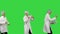Three male doctors in white robes and protective caps passing on document while dancing in a row on a Green Screen