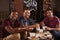 Three male friends eating a Chinese take-away look to camera