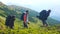 Three male hikers on beautiful mountain background.