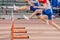 three male runners attack hurdle running 100 meters race