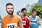 Three male runners during a race in city