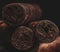 Three manly hand rolled havana cigars with shallow depth of field with dark back-round