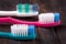 Three manual toothbrushes on the dark wooden background
