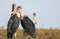 Three marabou storks leptoptilos crumenifures grazing in yellow grasslands at Liuwa Plain National Park