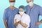 Three masked doctors together, a girl holds a heart model in her hands, the concept of treatment, transplantation, the concept of