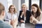 Three mature businesswomen having a conversation at conference table