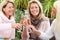 Three mature girlfriends with glasses of sparkling wine