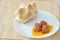 Three meatballs on a white dish with rosetta bread
