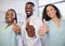Three medical healthcare professionals give thumbs up - Selective focus