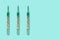 Three medical mercury thermometers in a row, close-up