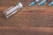 Three Medical Syringes And Vial On Rough Wood Board