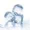 Three melting ice cubes on white background