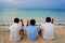 Three men face to ocean relaxing with cigarret at the beach in Playa de Bavaro, Punta cana, Dominican Republic.