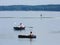 Three men have different fun on the water.