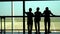 Three men are by the panoramic window at the airport. Silhouette of men. vietnam International Airport . A silhouette of