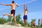 Three men play beach volley