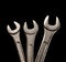 Three metallic wrenches