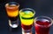 Three Mexican tequilla shots with multi colored alcoholic beverage served on table at party in night club.Enjoy strong liquor shot
