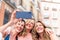 Three middle age female friends hugging together taking a selfie