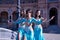 Three middle-aged Hispanic women, wearing turquoise costumes and rhinestones, to belly dance. Belly dance concept