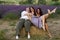 three middle-aged women friends laughing and having fun in lavender field