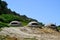 Three military bunkers from Enver Hoxha`s dictatorship near the beach at Cape of Rodon in Albania.