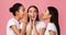 Three Millennial Girls Sharing Secrets Standing Over Pink Background, Panorama