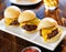 Three mini burger sliders in a row