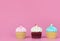 Three mini fancy cupcake on pink copy space