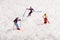 Three mini people skiing in fresh winter snow