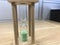 A three minutes Green color sand glass timer is active for an meeting time as a deadline for an task to an employee to complete