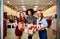 Three mixed race women with gift boxes in hands at store. Multi ethnic girls smiling with presents on christmas new year