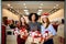 Three mixed race women with gift boxes in hands at store. Multi ethnic girls smiling with presents on christmas new year