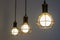 Three modern metal designer lamps, hanging