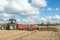 Three Modern tractors pulling ploughs