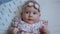 Three Months Old Baby Girl With Blue Eyes. Newborn Child, Little Adorable Peaceful and Attentive Girl Looking Surprised Smiling at