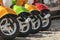 Three mopeds painted in red green yellow colors