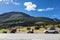 Three motorcycles and car standing on roadside of highway in mountains of Norway. Travel in Scandinavia by vehicles