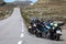 Three motorcycles standing roadside along narrow asphalt road in highland of Norway, Norwegian Scenic Route Aurlandsfjellet